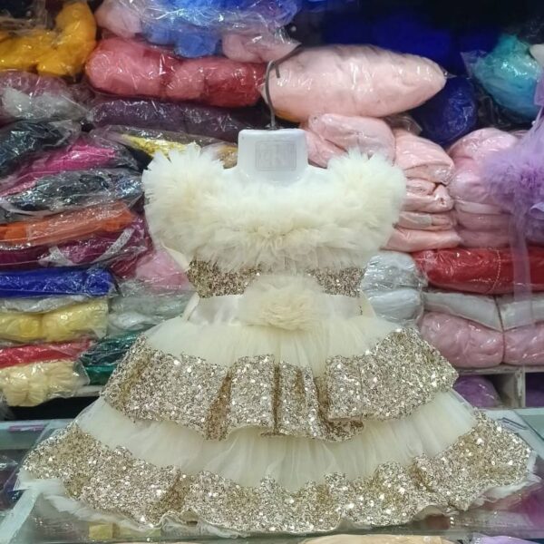 Premium Off-White Shimmery Baby Dress Ball Gown with gold sequin ruffled layers, off-the-shoulder fluffy net design, and floral waist accent - HKD932 - Kiddleplace