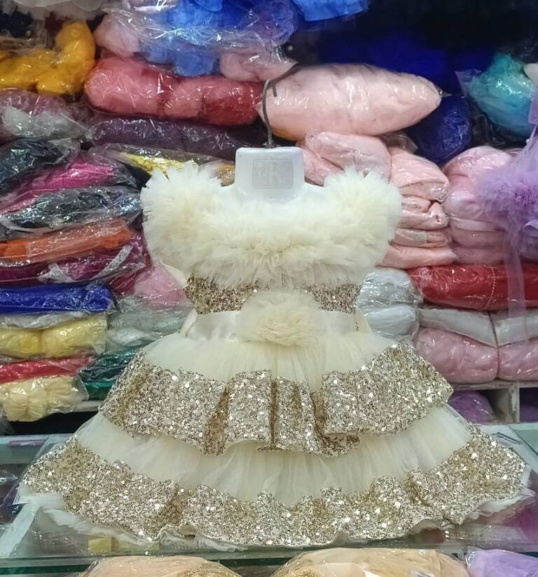 Premium Off-White Shimmery Baby Dress Ball Gown with gold sequin ruffled layers, off-the-shoulder fluffy net design, and floral waist accent - HKD932 - Kiddleplace