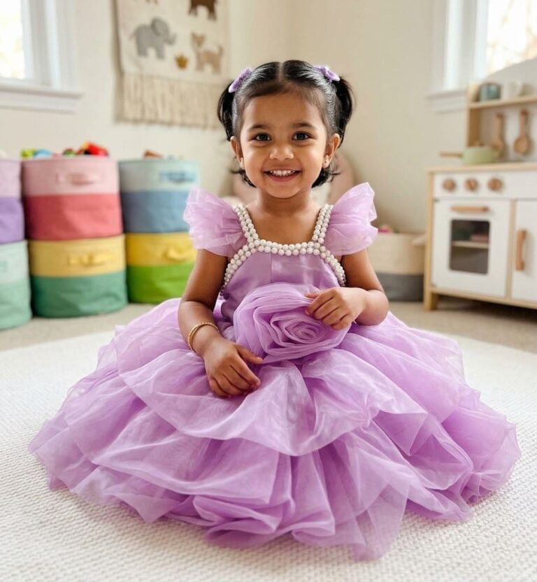 Little girl in a premium lilac purple party dress featuring a pearl-studded neckline and a large 3D organza rose on the skirt.