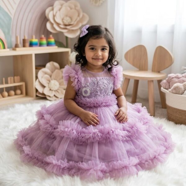 Toddler girl in a beautiful lavender purple layered ruffle net gown with intricate bodice embroidery.