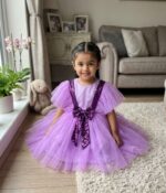 Lavender baby girl party dress with purple sequin V-strap design and fluffy net skirt.