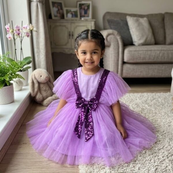 Lavender baby girl party dress with purple sequin V-strap design and fluffy net skirt.