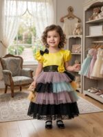 Yellow and multicolor layered party dress for girls with black sequin bow and lace tiers.