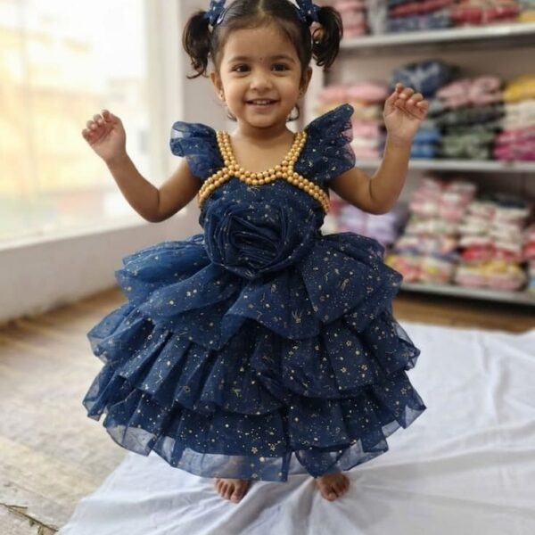 Baby girl wearing a royal navy blue shimmery net party frock with golden pearls and 3D rose